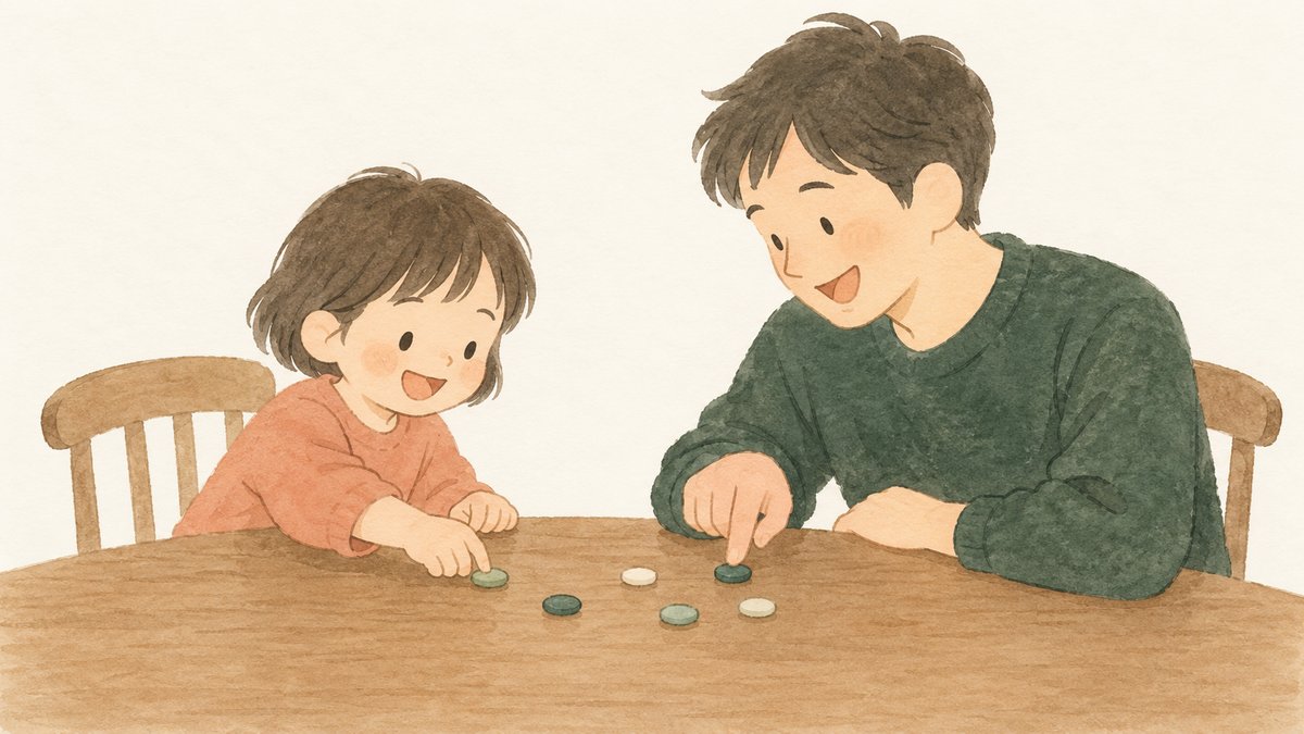 お父さんが、机に物を置いて、子どもと一緒に動かしている
